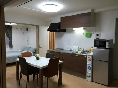a kitchen and dining room with a table and chairs at Isshuku Ryokan Asakusabashi - Vacation STAY 17353v in Tokyo