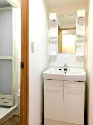 a bathroom with a white sink and a mirror at Isshuku Ryokan Asakusabashi - Vacation STAY 17353v in Tokyo