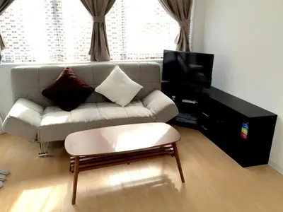 a living room with a couch and a tv at Isshuku Ryokan Asakusabashi - Vacation STAY 17346v in Tokyo