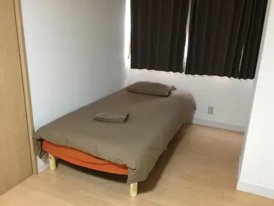 a small bed in a small room with a window at Isshuku Ryokan Asakusabashi - Vacation STAY 17346v in Tokyo