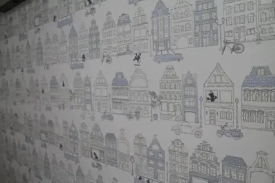 a wall with drawings of buildings on it at Okubo Hotel Hawaii in Tokyo