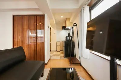 a living room with a couch and a television at HOTEL AIS HATAGAYA in Tokyo