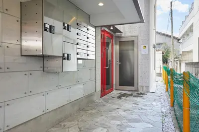 a red door on the side of a building at HOTEL AIS HATAGAYA in Tokyo