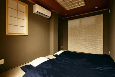 a bedroom with a bed and a window with a air conditioner at 634 Condo Yotsuya - Vacation STAY 14799v in Tokyo