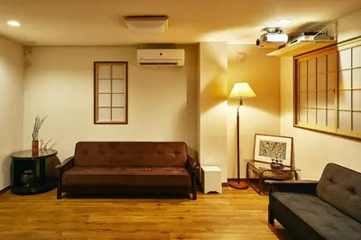 a living room with a couch and a lamp at 634 Condo Yotsuya - Vacation STAY 14799v in Tokyo