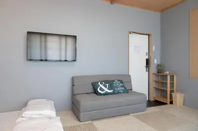 a living room with a chair and a window at Light Hotel - Vacation STAY 17340v in Tokyo