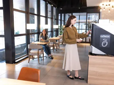 a woman is standing at a podium in a building at Tokyu Stay Shinjuku Eastside in Tokyo