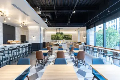 a restaurant with tables and chairs and a bar at Tokyu Stay Shinjuku Eastside in Tokyo