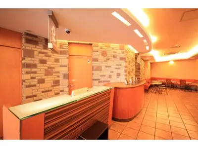 a restaurant with a bar and tables in a room at R&B Hotel Otsuka Eki Kitaguchi - Vacation STAY 14229v in Tokyo