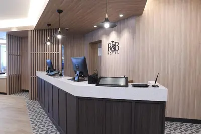 an office lobby with a counter with a computer on it at R&B Hotel Otsuka Eki Kitaguchi - Vacation STAY 14229v in Tokyo