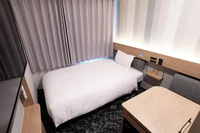 a small hotel room with a bed and a desk at R&B Hotel Otsuka Eki Kitaguchi - Vacation STAY 14225v in Tokyo