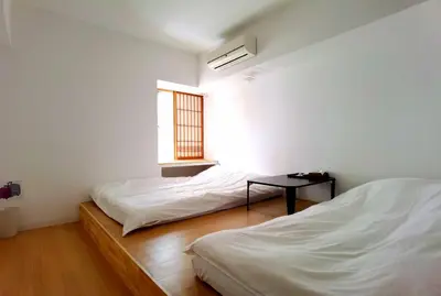 two beds in a room with a table and a window at belle via tokyo - Vacation STAY 18577v in Tokyo