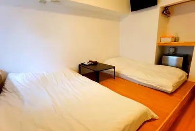 a room with two beds and a table in it at belle via tokyo - Vacation STAY 18577v in Tokyo