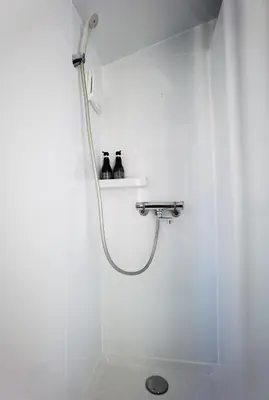 a shower with a hose in a white bathroom at belle via tokyo - Vacation STAY 18577v in Tokyo