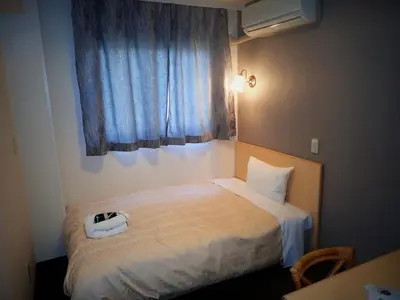 a bedroom with a bed with a phone on it at Hotel Suntargas Ueno - Vacation STAY 08468v in Tokyo