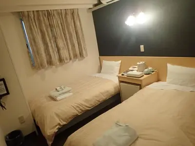 two beds in a hotel room with towels on them at Hotel Suntargas Ueno - Vacation STAY 08478v in Tokyo