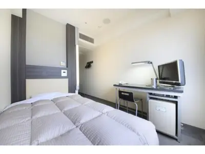 a bedroom with a bed and a desk with a television at R&B Hotel Tokyo Toyocho - Vacation STAY 14255v in Tokyo
