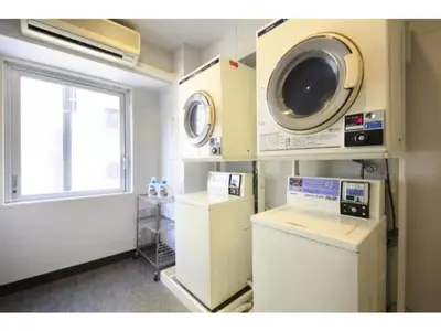 a laundry room with a washing machine and a window at R & B Hotel Kamata Higashiguchi - Vacation STAY 14841v in Tokyo