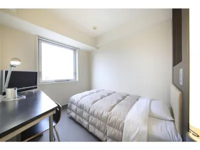 a bedroom with a bed and a desk and a window at R & B Hotel Kamata Higashiguchi - Vacation STAY 14835v in Tokyo