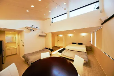 a room with two beds and a table in it at 634 Condo Shinjuku - Vacation STAY 14798v in Tokyo