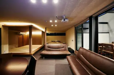 a living room with leather furniture and a bed at 634 Condo Shinjuku - Vacation STAY 14798v in Tokyo