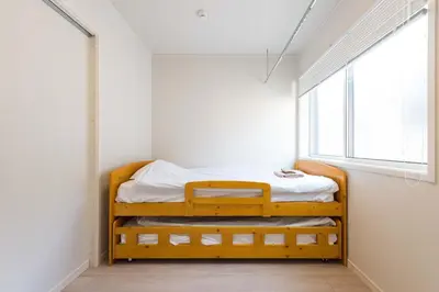 a bed in a room with a window at Terrace house omori in Tokyo