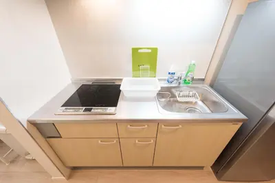 a small kitchen with a sink and a stove at Terrace house omori in Tokyo
