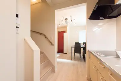 a kitchen with a staircase and a dining room at Terrace house omori in Tokyo