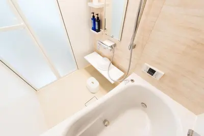 a white bathroom with a tub and a shower at Terrace house omori in Tokyo