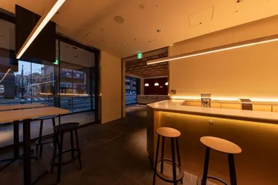 a bar in a restaurant with stools and a counter at The Kanzashi Tokyo Asakusa in Tokyo