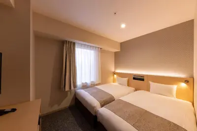 a hotel room with two beds and a window at The Kanzashi Tokyo Asakusa in Tokyo