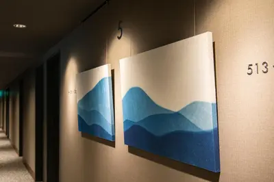 a row of three paintings on a wall at The Kanzashi Tokyo Asakusa in Tokyo