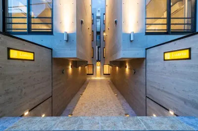an empty hallway in a building with lights at Luana Shibuya in Tokyo