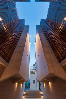 a view from between two tall buildings with stairs at Luana Shibuya in Tokyo