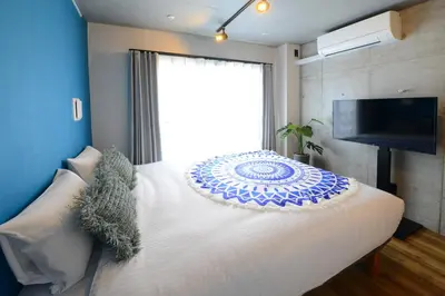 a bedroom with a large bed with a large window at Luana Shibuya in Tokyo
