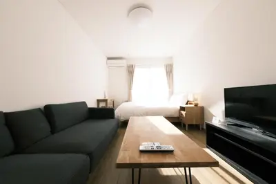 a living room with a couch and a television at Noah Ikebukuro - Vacation STAY 10604 in Tokyo