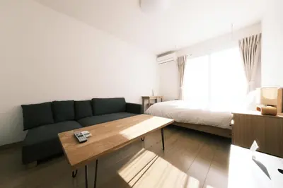 a living room with a couch and a bed at Noah Ikebukuro - Vacation STAY 10604 in Tokyo