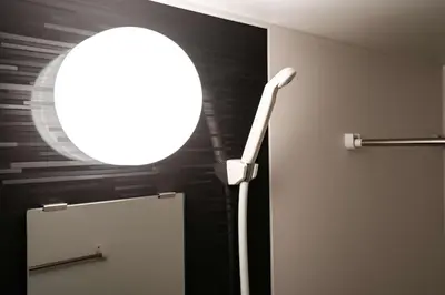 a bathroom with a mirror and a light on the wall at Noah Ikebukuro - Vacation STAY 10604 in Tokyo