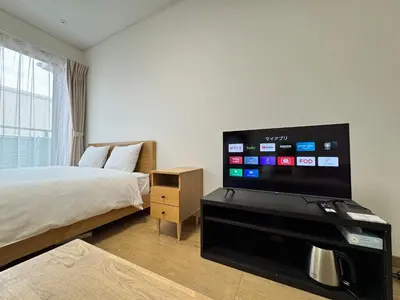 a bedroom with a bed and a flat screen tv at Noah Ikebukuro - Vacation STAY 10604 in Tokyo