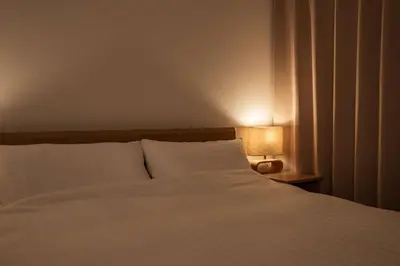 a bedroom with a white bed and a lamp at Noah Ikebukuro - Vacation STAY 10604 in Tokyo