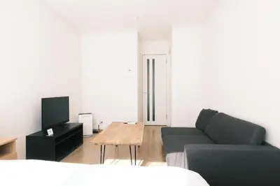 a living room with a couch and a coffee table at Noah Ikebukuro - Vacation STAY 10604 in Tokyo