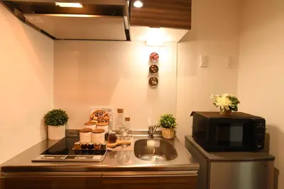 a kitchen counter with a microwave and a sink at FL Residence Asakusa in Tokyo