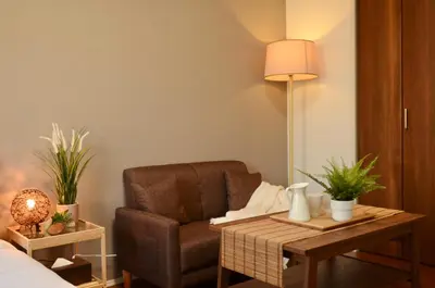 a room with a chair and a table with a lamp at FL Residence Asakusa in Tokyo