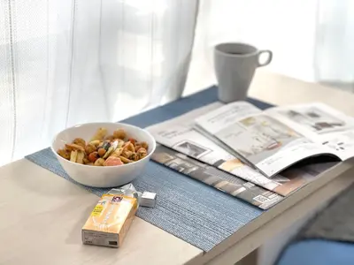 a table with a bowl of nuts and a book at FL Residence Asakusa in Tokyo