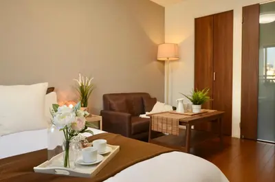 a hotel room with a bed and a chair at FL Residence Asakusa in Tokyo