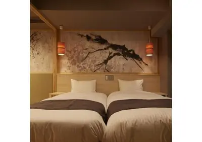 two beds in a room with a painting on the wall at Sakura Sky Hotel - Vacation STAY 18442v in Tokyo