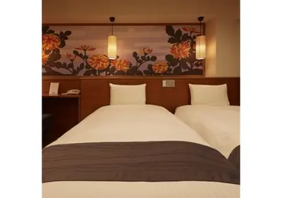 two beds in a hotel room with flowers on the wall at Sakura Sky Hotel - Vacation STAY 18449v in Tokyo