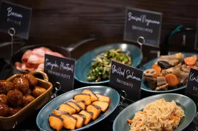 a buffet of different types of food in bowls at DEL style Ikebukuro Higashiguchi by Daiwa Roynet Hotel in Tokyo