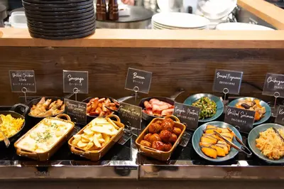 a buffet of different types of food on display at DEL style Ikebukuro Higashiguchi by Daiwa Roynet Hotel in Tokyo