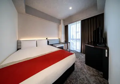 a hotel room with a bed and a television at DEL style Ikebukuro Higashiguchi by Daiwa Roynet Hotel in Tokyo